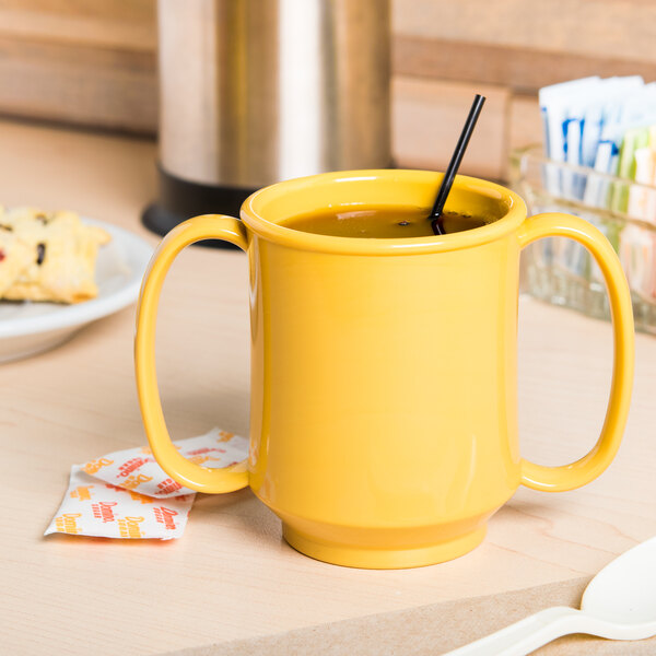 A yellow GET Tritan plastic mug with two handles and a black straw.