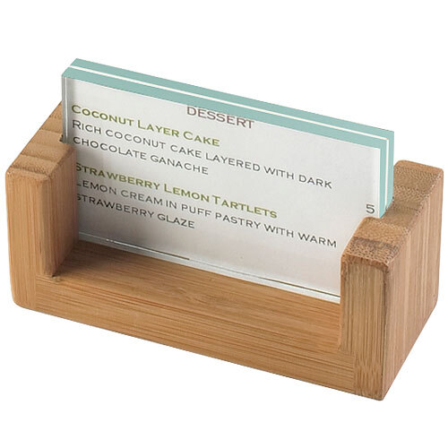A Cal-Mil bamboo displayette with a U-shaped bamboo frame holding a business card.