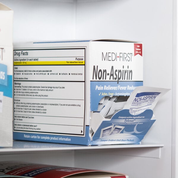 A red Medi-First box of non-aspirin acetaminophen tablets on a shelf.