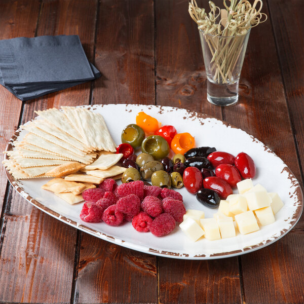 A white GET Osslo melamine platter with cheese, crackers, and fruit on it.