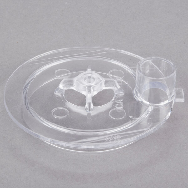 A clear plastic object with a hole in it.