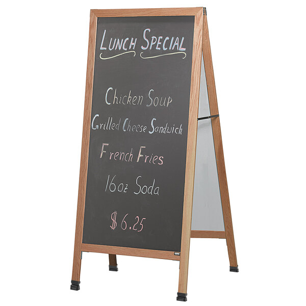 An Aarco solid oak A-frame sidewalk board with black composition chalk board with the words "Lunch Special" written on it.