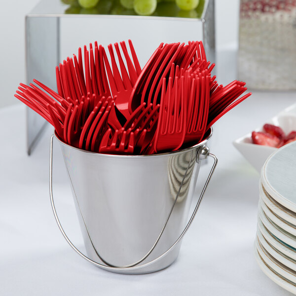 A bucket filled with red Creative Converting plastic forks.