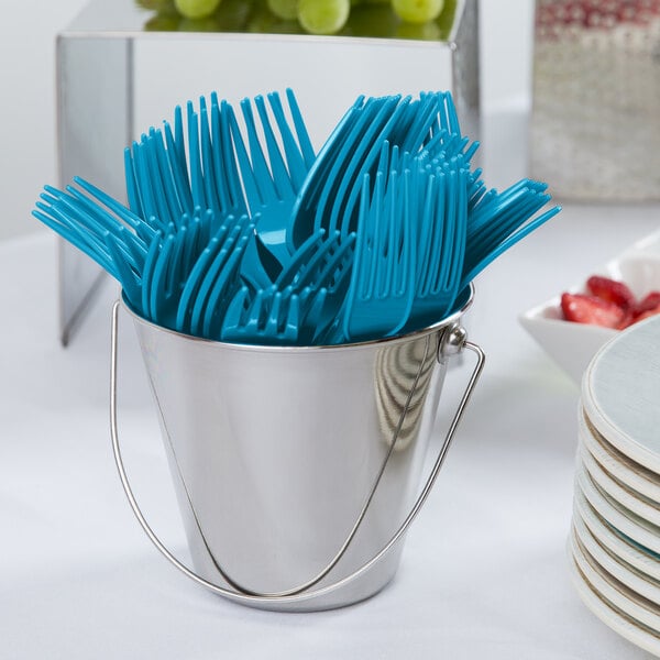 A bucket of turquoise plastic forks.