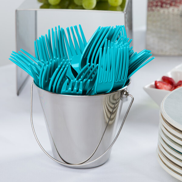 A bucket of blue plastic utensils including Bermuda Blue plastic forks.