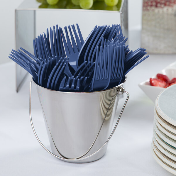 A bucket filled with navy blue plastic forks.