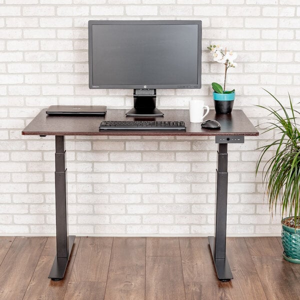 A Luxor standing desk with a computer on it.