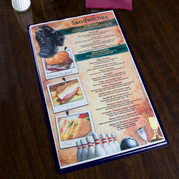A dark blue Hamilton menu board on a table with a menu inside.