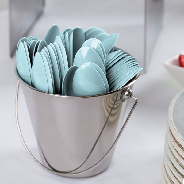 A bucket filled with blue Creative Converting plastic spoons.