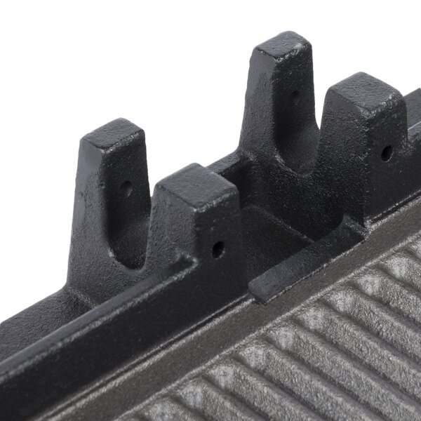 A close-up of the grooved black metal bottom of an Avantco grill plate.