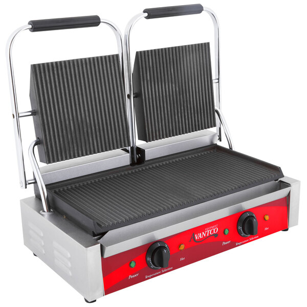 An Avantco grooved bottom grill plate in a sandwich grill.