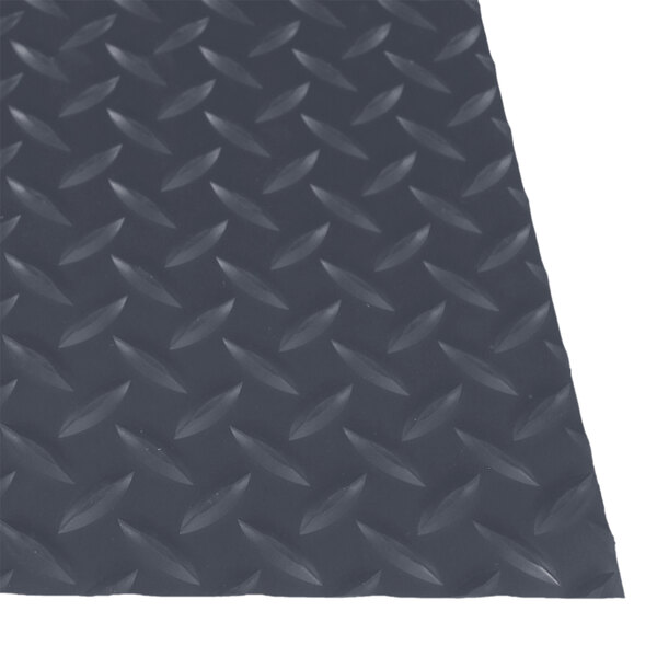 A close-up of a gray rubber diamond plate surface.