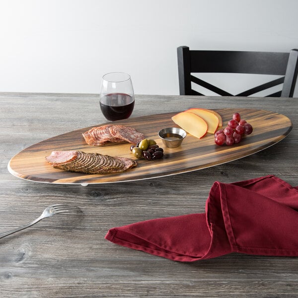 An American Metalcraft faux acacia melamine serving board on a table with food and wine.