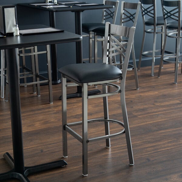 Lancaster Table & Seating Clear Coat Finish Cross Back Bar Stool with 2 1/2" Black Vinyl Padded Seat - Assembled