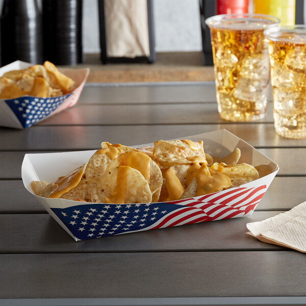 A container of patriotic potato chips in a #500 USA flag paper food tray.