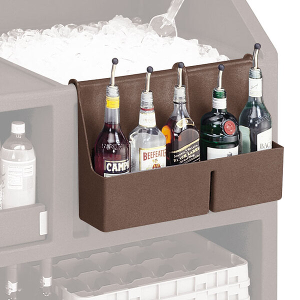 A dark brown Cambro speed rail with bottles of liquor on a counter.