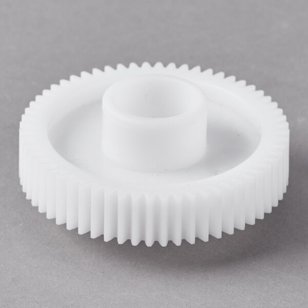 A white plastic gear with a circle hole.