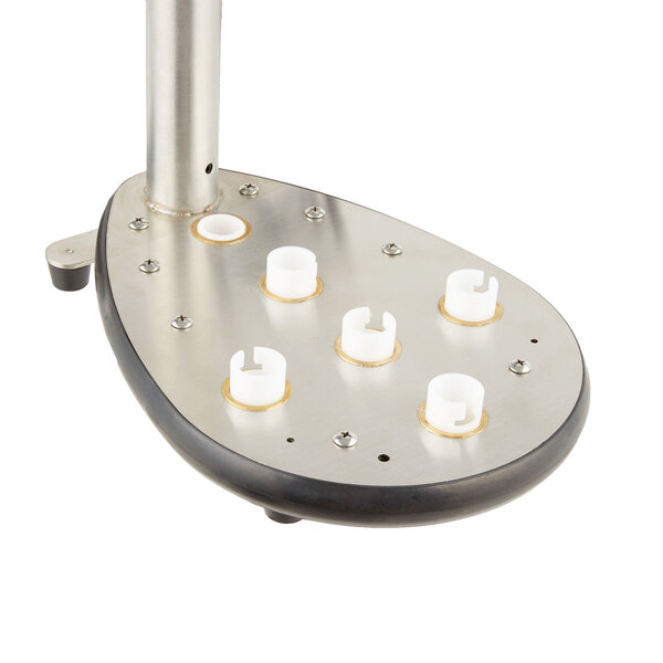 A bronze metal Noble Products gear bearing with white plastic caps on it.