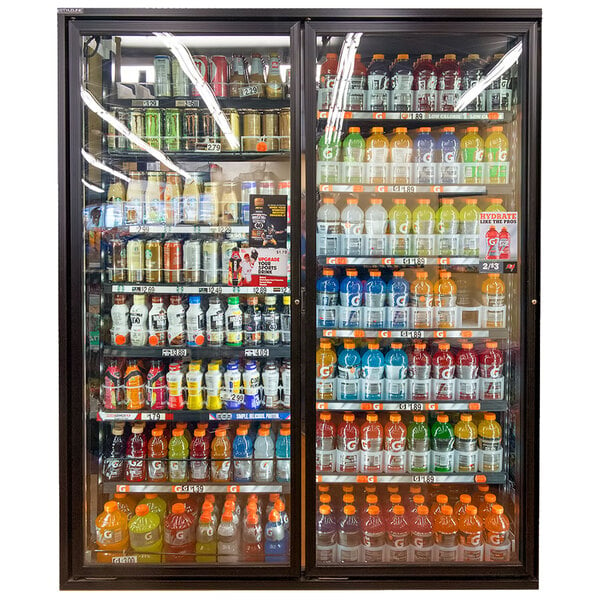 A room with Styleline walk-in cooler doors filled with drinks on shelves.