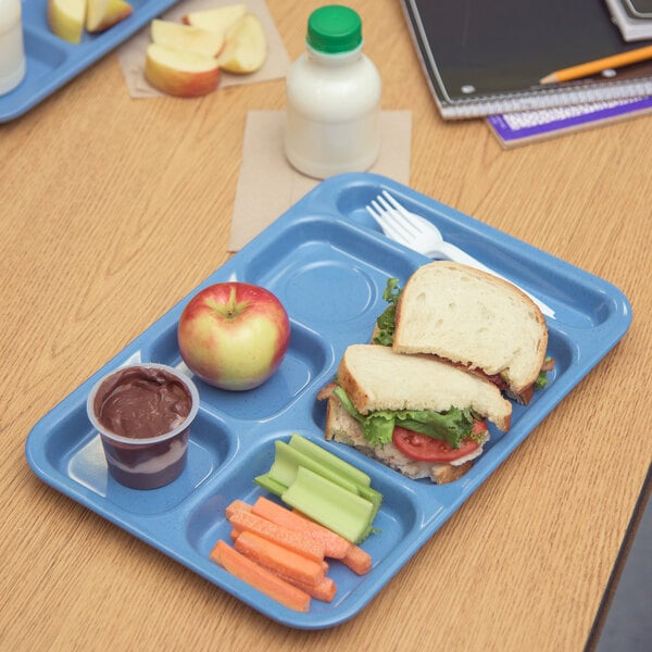 A Carlisle 6 compartment tray with sandwiches, carrots, and an apple.