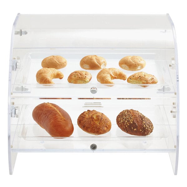 A clear acrylic bakery display case with trays of bread and pastries including croissants, rolls, and loaves of bread.