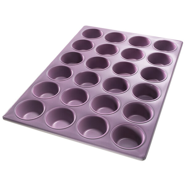 A purple Chicago Metallic muffin pan with 24 holes.