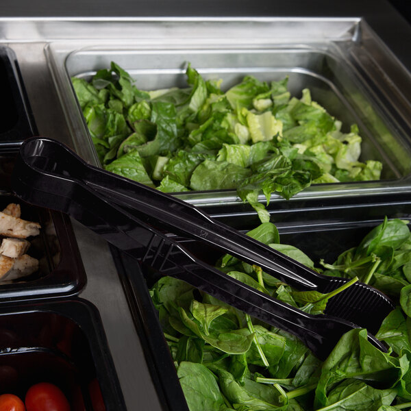 Black Thunder Group polycarbonate flat grip tongs in a salad bar full of food.