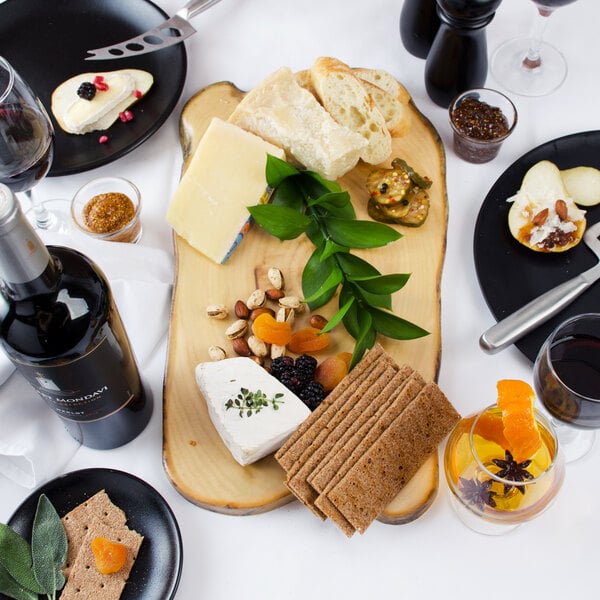 An American Metalcraft melamine serving board with food and wine on a table.