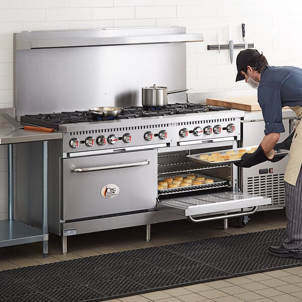 A man putting food into a Cooking Performance Group 60" range oven.