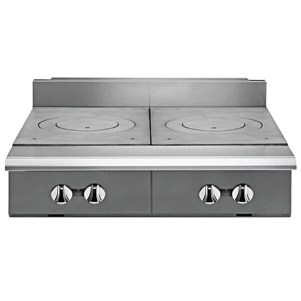 A close-up of a Vulcan stainless steel modular range with two French plates.