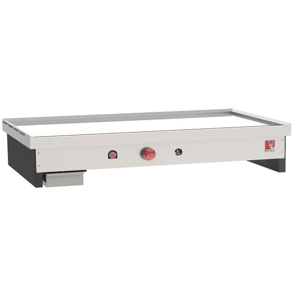 A white rectangular Wolf Teppanyaki gas countertop griddle with red buttons.