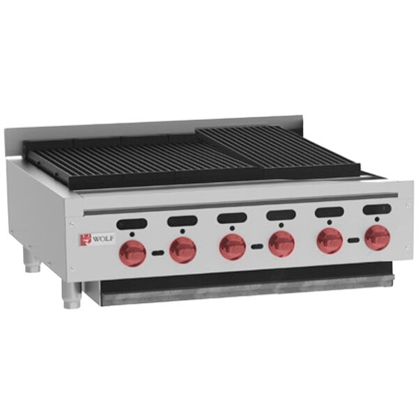 A Wolf natural gas countertop charbroiler with red knobs on the grill.