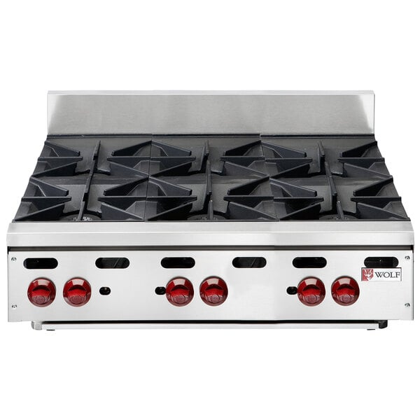 A Wolf stainless steel countertop range with six burners.