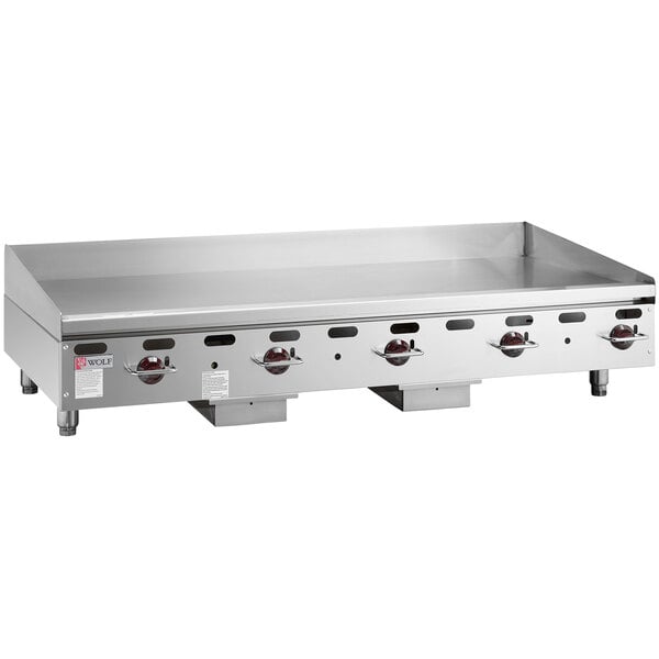 A large stainless steel Wolf countertop griddle with manual controls.