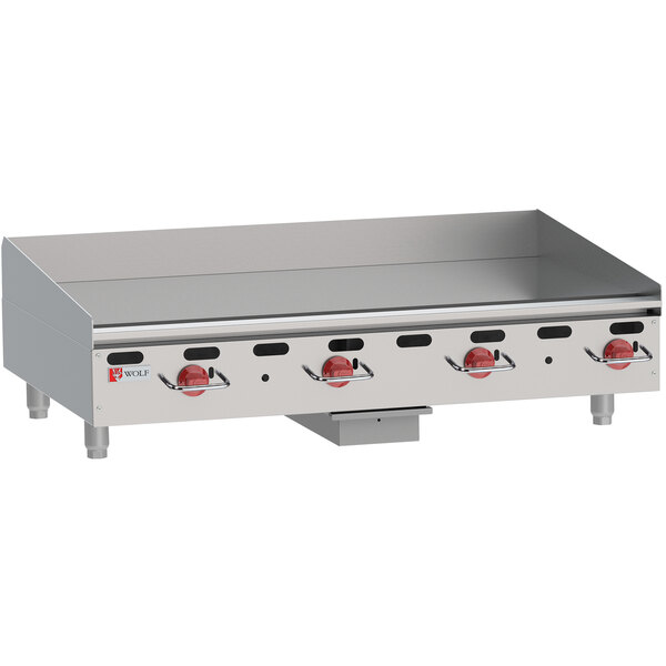 A Wolf stainless steel gas countertop griddle with manual controls.