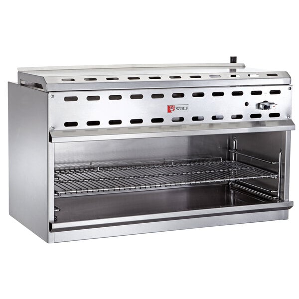 A Wolf stainless steel cheese melter with a rack on a shelf.