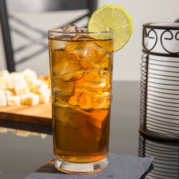 A Libbey Puebla beverage glass of iced tea with lime and ice.