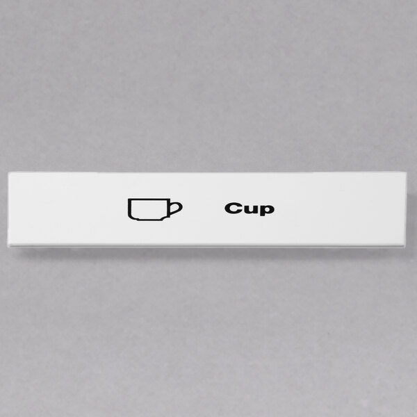 A white rectangular Cambro cup extender ID clip with a black and white cup on it.