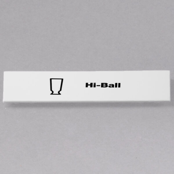 A white rectangular object with black text that says "Hi Ball" on a counter.