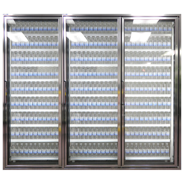 Three Styleline glass walk-in cooler doors with shelving holding water bottles.