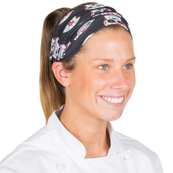 A woman wearing a black and white Headsweats headband with a skull pattern.