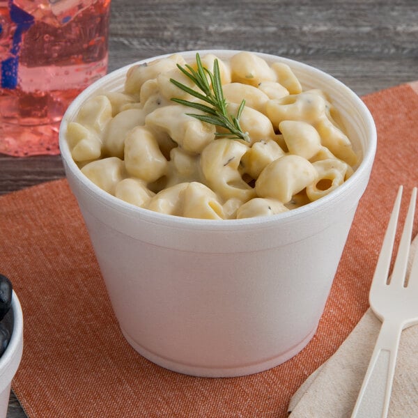 A cup of macaroni and cheese in a Dart foam container.
