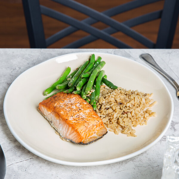 A plate with salmon, green beans, and rice on it.
