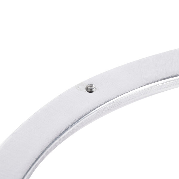 A close-up of a metal ring with a hole.