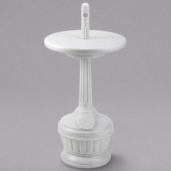 A white pedestal with a round base and a pillar with a white ashtray on top.
