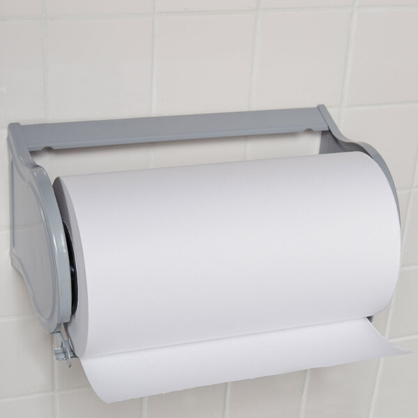 A Bulman gray steel paper dispenser with a roll of paper on a white wall.