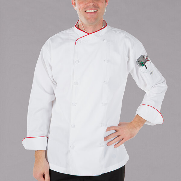 A man wearing a white Mercer Culinary chef's coat with red piping.