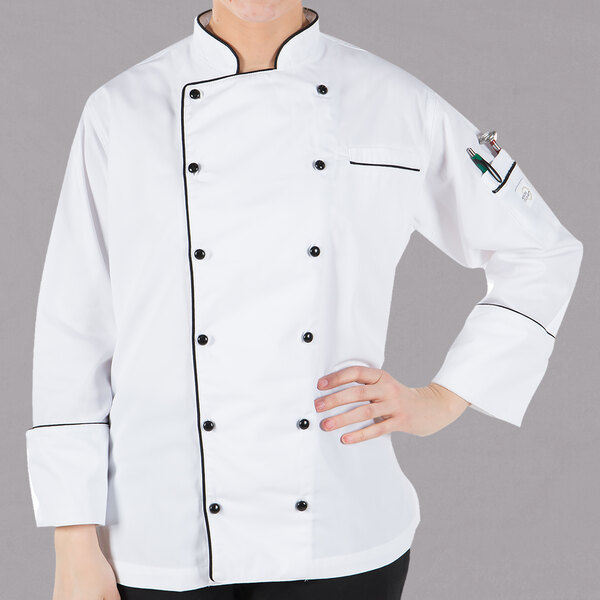 A woman wearing a white Mercer Culinary chef coat with full black piping.