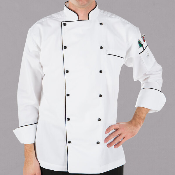 A man wearing a white Mercer Culinary chef jacket with black piping.