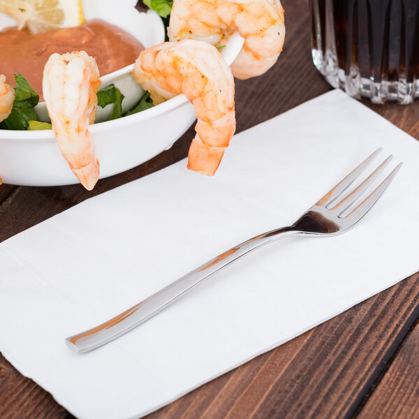 A Libbey stainless steel cocktail fork with a bowl of shrimp.